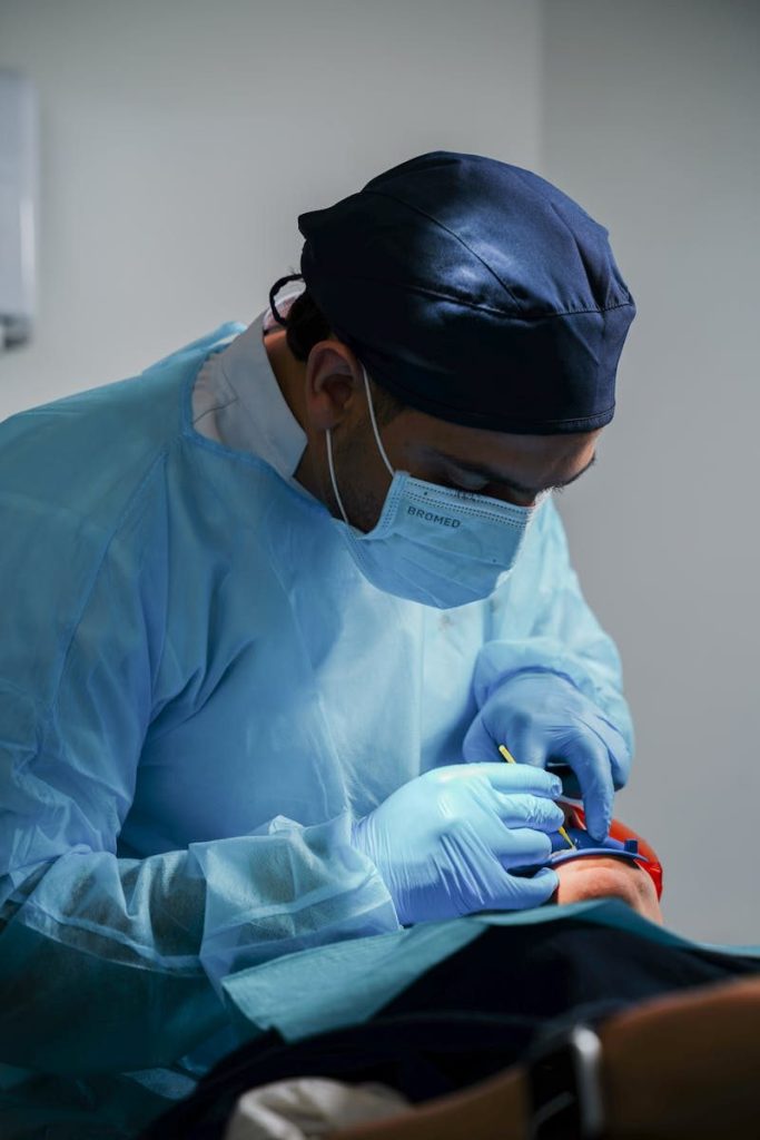 A dentist performing a complex dental procedure using modern surgical equipment.